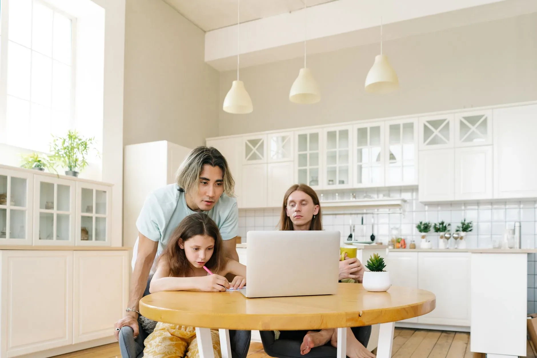 A girl being home schooled by her family at a table