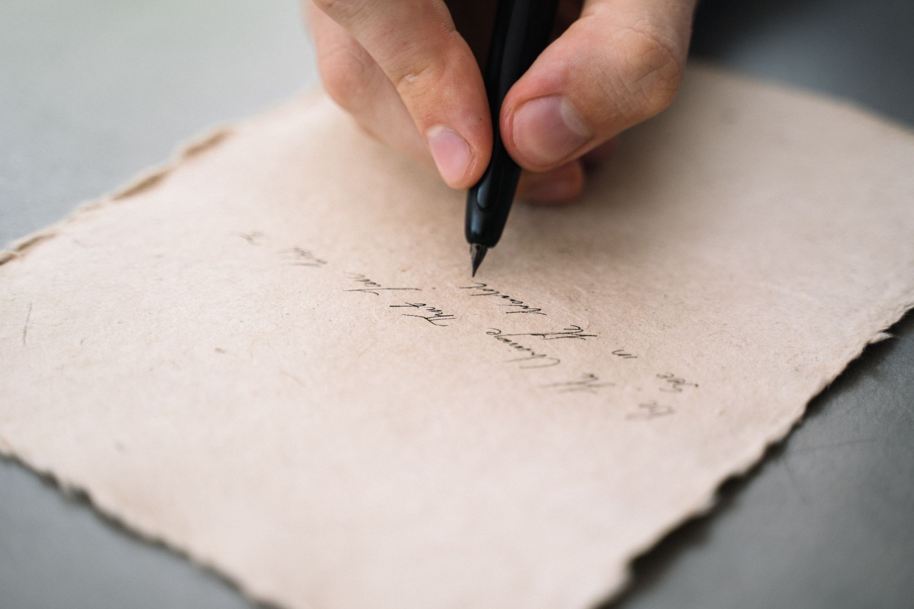 A close-up of a person writing notes on paper