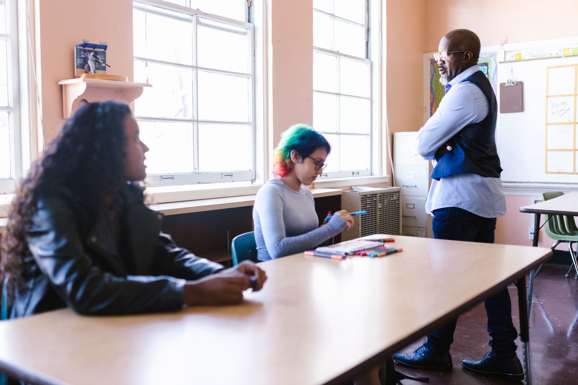 A teacher meeting with parents across a table